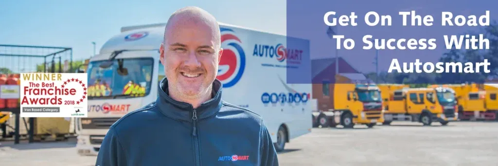 Autosmart franchise owner standing in front of branded van and vehicles