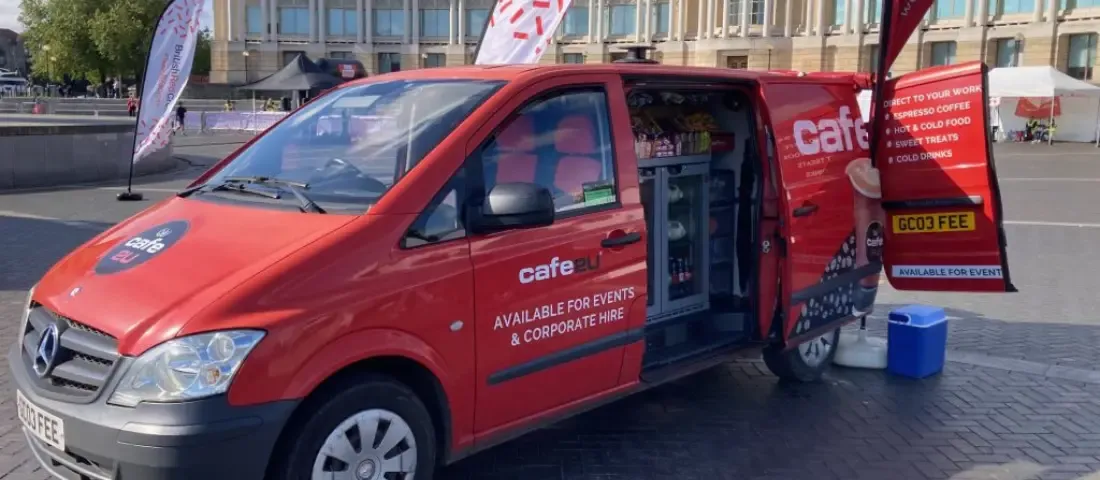 Café2U mobile coffee van franchise banner showing barista service